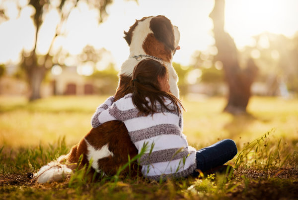 girl hugging dog